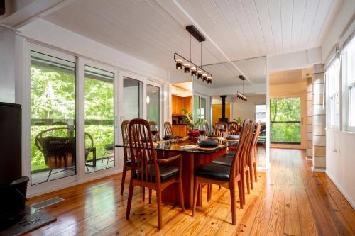 a dining room with a table and chairs at TreeTops Spacious Architectural Retreat in Gainesville