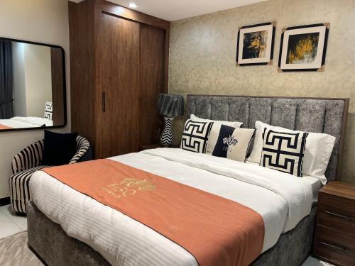 a bedroom with a large bed and a mirror at HSQ Towers in Murree