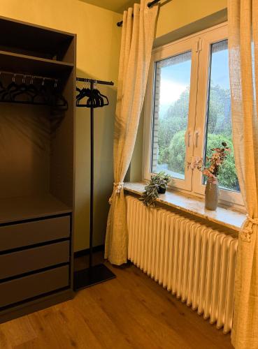 a room with a window with a radiator and a window with a window treatment at TheSlowMorningNo1 in Cuxhaven