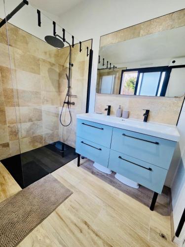 a bathroom with a blue sink and a shower at Mas des châtaigniers in Le Vigan