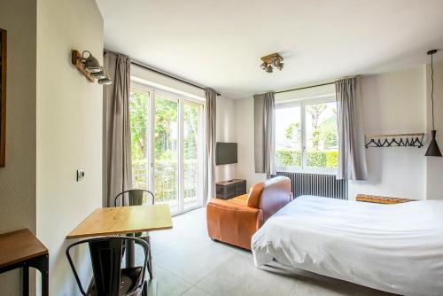 a hotel room with a bed and a chair at Appartamenti 1 in Dervio