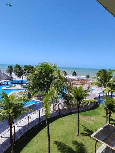 a view of the beach from the balcony of a resort at Hotel pirâmide natal in Natal