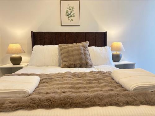a bedroom with a large bed with a brown blanket at Seaside Apartments Redcar in Redcar