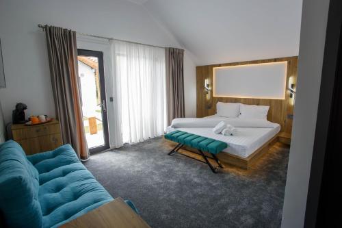 a hotel room with a bed and a couch at Danube Delta Bungalows Gorgova in Gorgova