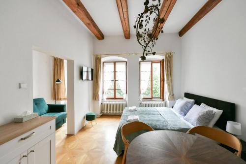 a room with a bed and a table and a couch at TINY HOUSE Old Town in Prague
