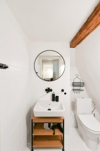 a white bathroom with a sink and a mirror at TINY HOUSE Old Town in Prague