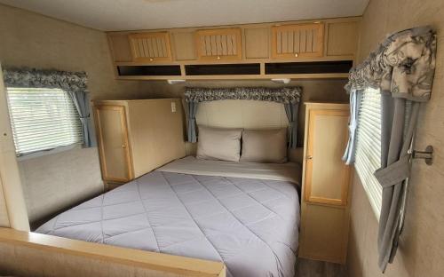 a small bed in the back of a rv at RV with Rocky Mountains View in McBride