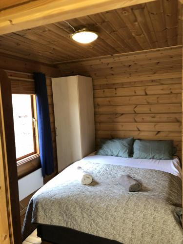 a bedroom with a bed in a log cabin at Timber cabin, centrally located in Bodø in Bodø