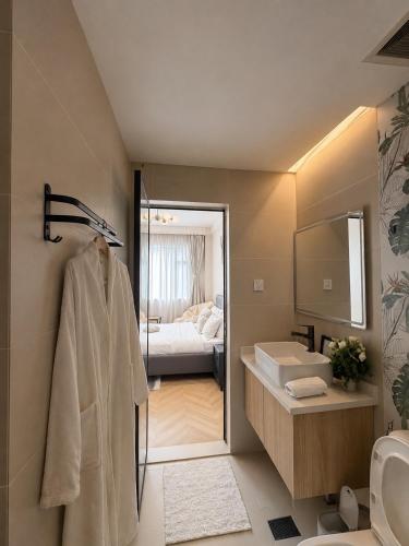 a bathroom with a sink and a toilet and a bed at Oderm one bedroom apartment in Syokimau near jkia airport and sgr station in Nairobi in Nairobi