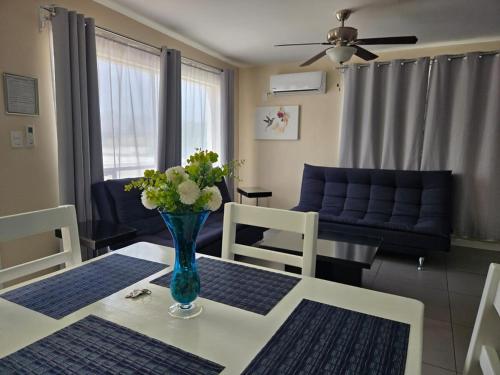 a living room with a table with a vase of flowers on it at Independent apartment in San Antonio