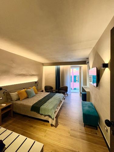 a bedroom with a bed and a living room at Ca' De Carme' in Riomaggiore