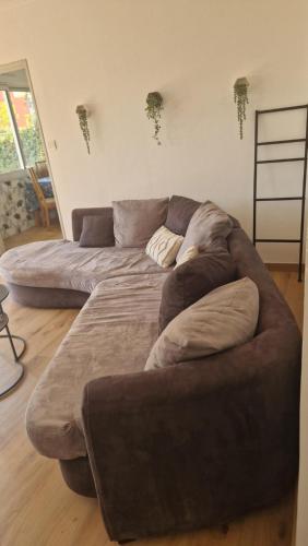 a large couch sitting in a living room at Les Hautains in Saint-Genis-Pouilly