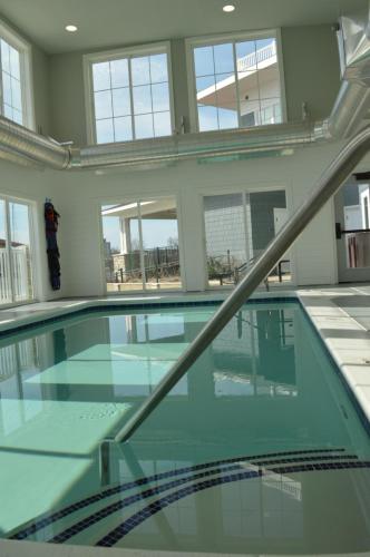 a swimming pool in a building with windows at The Inn at Harbor Shores in Saint Joseph