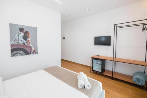 a bedroom with a bed and a tv on a wall at Riverside Villa in Tragjas