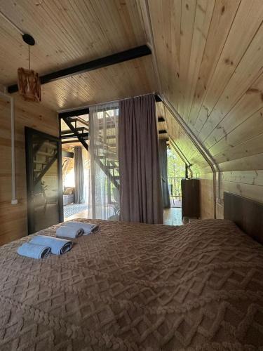 a large bed with two towels on top of it at Cottage Green Horizon Buknari in Buknari