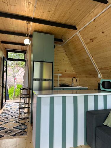 a kitchen with a striped counter in a house at Cottage Green Horizon Buknari in Buknari