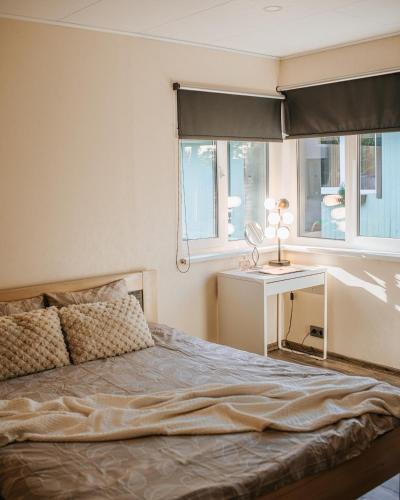 a bedroom with a bed with a desk and a window at Feels like home just 10 mins from the centre in Tallinn
