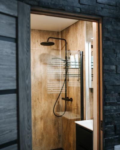 a bathroom with a shower with a shower head at Feels like home just 10 mins from the centre in Tallinn