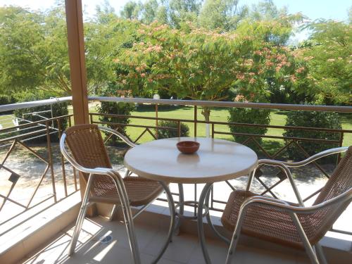 a white table and chairs on a balcony at Zisis Garden Studios in Ioannina