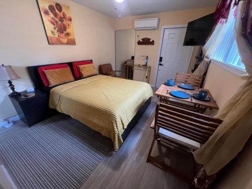 a small bedroom with a bed and a table at Twin Pines Studios in Jacksonville