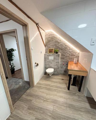 a bathroom with a staircase with a toilet and a sink at Penzion Mlýnický Dvůr in Červená Voda