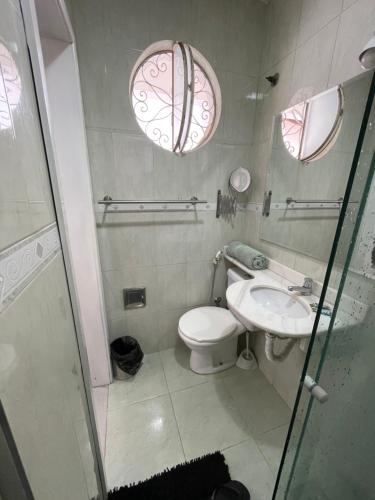 a bathroom with a toilet and a sink at Suíte da Fran - Perto da UFF in Niterói