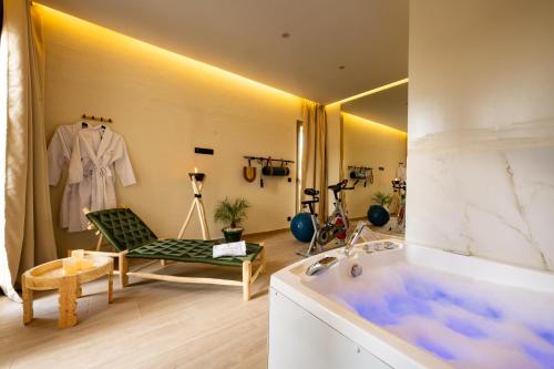 a bathroom with a tub and a chair and a mirror at Luxurious Marrakech Villa Pool, Hammam,Cinema in Marrakesh