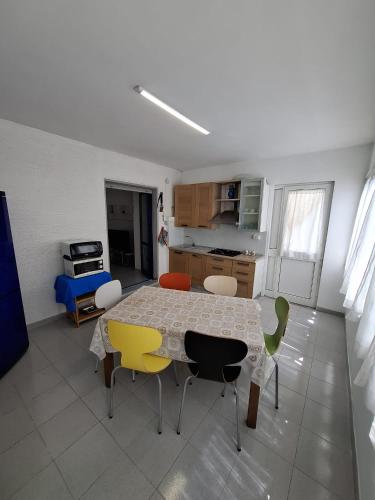 a kitchen with a table and chairs in a room at La casa del delfino in Policoro