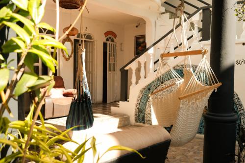 a room with two hammocks hanging from the stairs at Mandala’s Hostal in San Pedro La Laguna