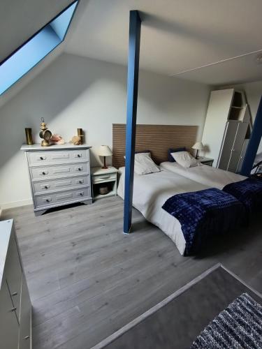 a bedroom with a large bed and a dresser at Trégouet 8 - Chambre 3 in Saint-Nazaire