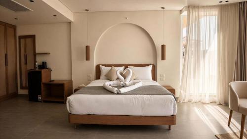 a bedroom with a large bed with two pillows at Selena Bay Hotel Suites in Hurghada
