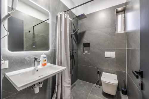 a bathroom with a sink and a toilet at Crystal Beach Rooms by PS in Durrës