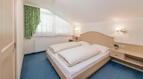 Ένα ή περισσότερα κρεβάτια σε δωμάτιο στο Appartements Buggl's