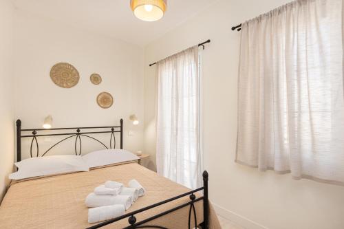 a bedroom with a bed with towels on it at Aesop Homes in Pythagoreio