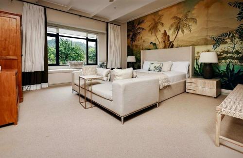 a large bedroom with a bed and a couch at Highveldt Farm, Nottingham Road in Fort Nottingham
