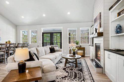 a living room with a couch and a fireplace at Four Sisters Cottage- Walk to Sister Bay, Fireplace, Ping Pong & More in Sister Bay