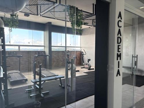 a gym with two tread machines and a glass door at Studio in Barbacena