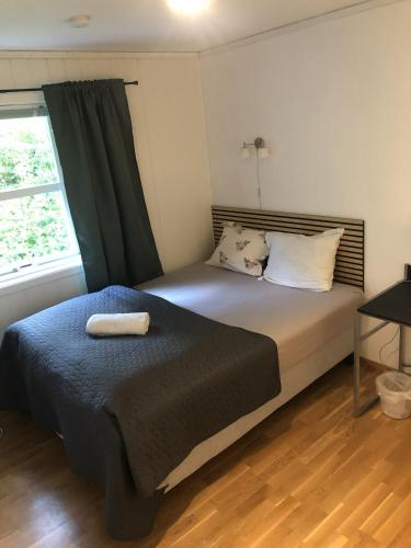 a bedroom with a bed with a towel on it at Private room on quiet street in Bodø