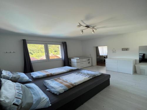 a bedroom with two beds and a window at Wienerwaldblick in Mauerbach