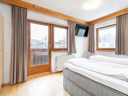 a hotel room with two beds and a window at An der Ache XL in Kirchberg in Tirol
