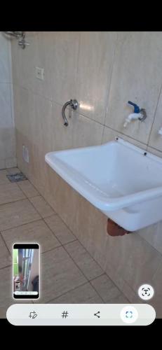 a bathroom with a white sink and a mirror at Casa céntrica de 2 dormitorios in Cañada de Gómez