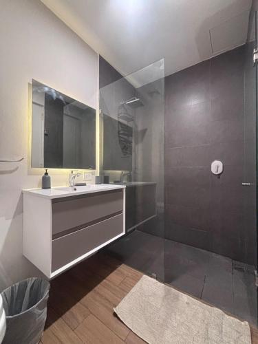 a bathroom with a sink and a mirror and a shower at Guadalajara American visa - 2 bedrooms in Milpillas