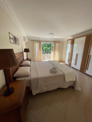 a bedroom with a large bed and a window at Sobrado Savana in Foz do Iguaçu