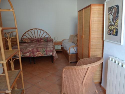 a living room with a table and a chair at CASA Pitosforo CASA Ulivo in Forio d'Ischia