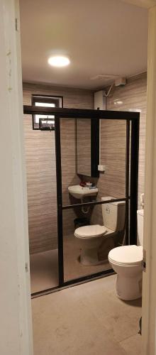 a bathroom with a toilet and a sink at Melinda place in Camarin