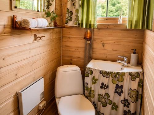 a small bathroom with a toilet and a sink at Ryten View Retreat in Hovdan