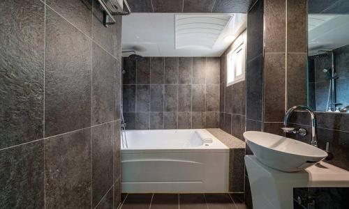 a bathroom with a tub and a toilet and a sink at Anyang ILLOWA Hotel in Anyang