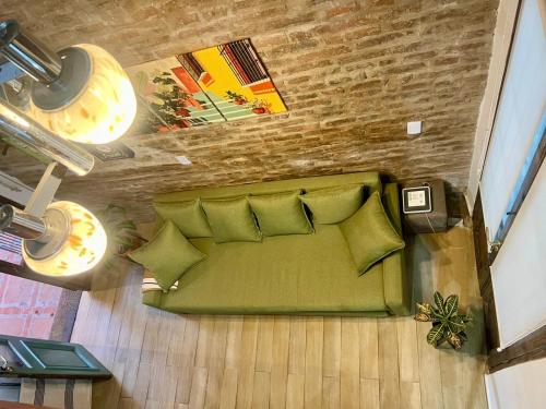 an overhead view of a green couch in a living room at Loft con patio frente a Mercado San Telmo, 2 baños in Buenos Aires