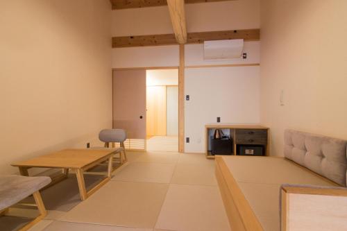a living room with a couch and a table at SATOYAMA STAY Nino-Machi in Furukawachō