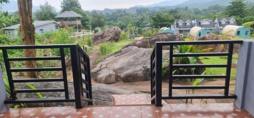a balcony with a view of a giraffe at Farm Terrace in Kaengsopha